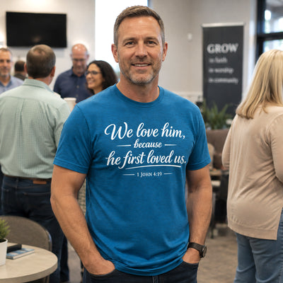 "We Love Him Because He First Loved Us" 1 John 4:19 Christian T-Shirt | Gildan 6400 Soft Style Tee | Faith-Based Bible Verse Shirt for Men & Women